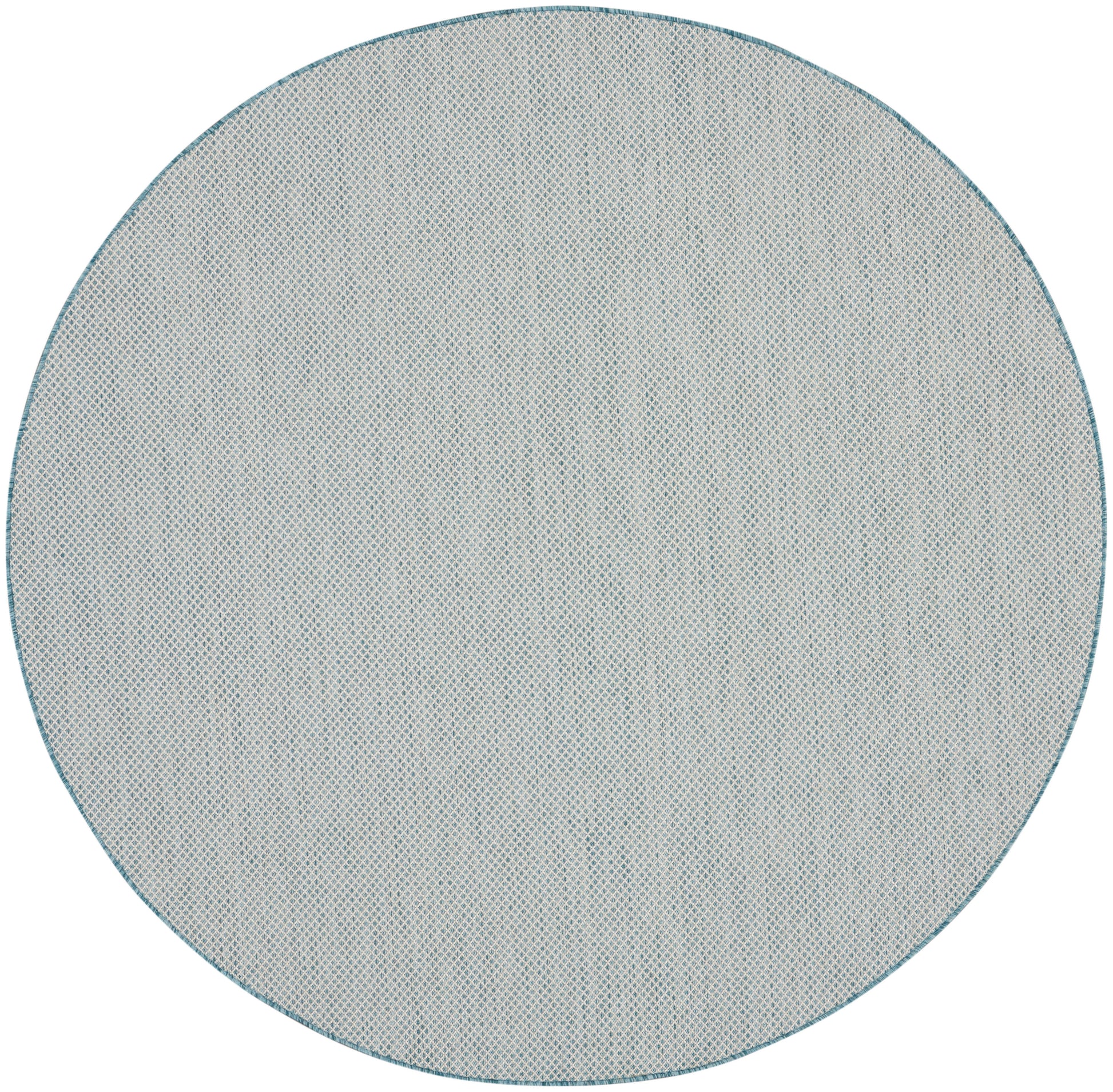 Round blue-gray, fabric-textured rug with a tiny dot pattern and teal edge.