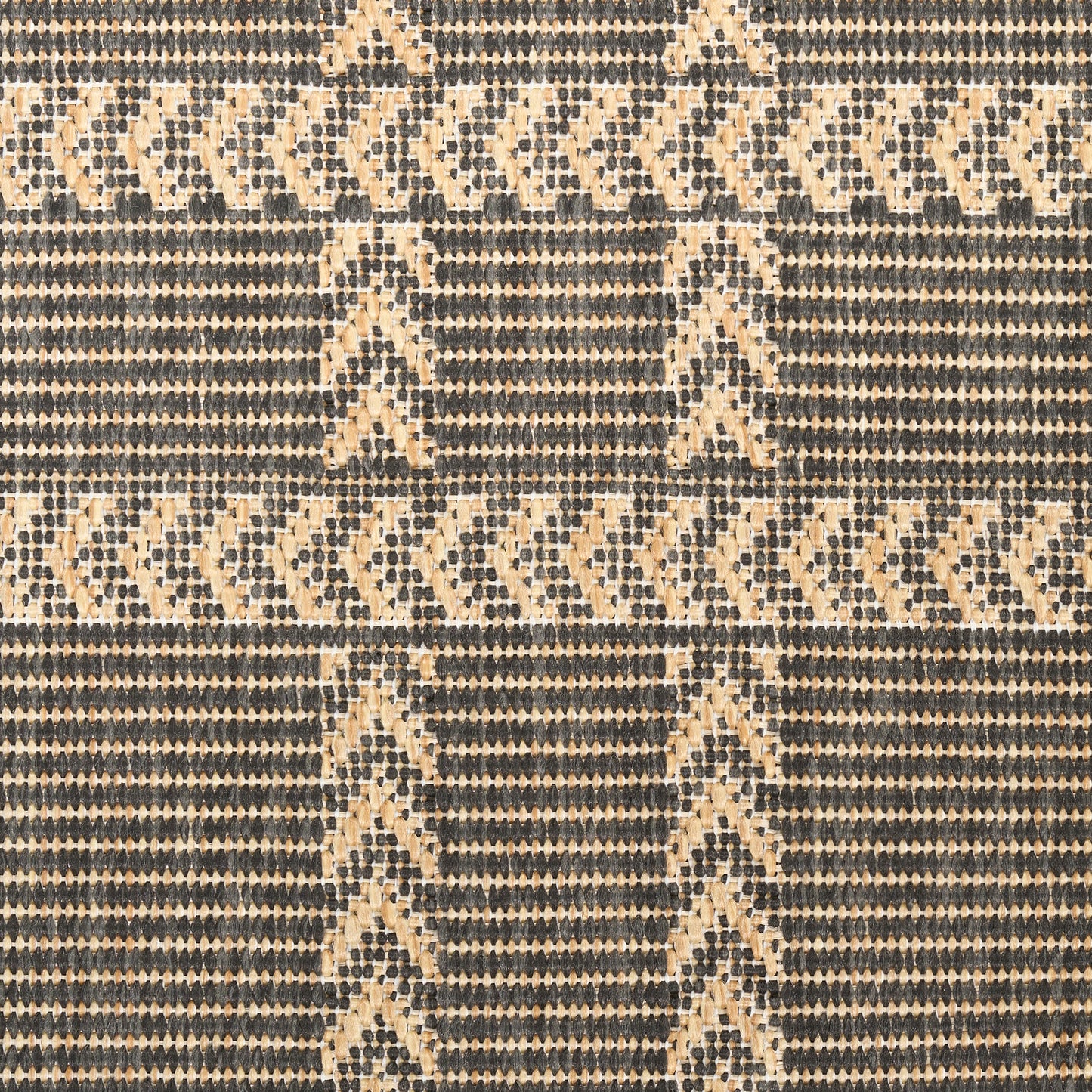 Tan and navy woven rug with repeating chevron and diamond motifs