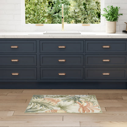 Navy blue shaker cabinets with copper handles, white marble counter, brass faucet, tropical rug on wood floor.