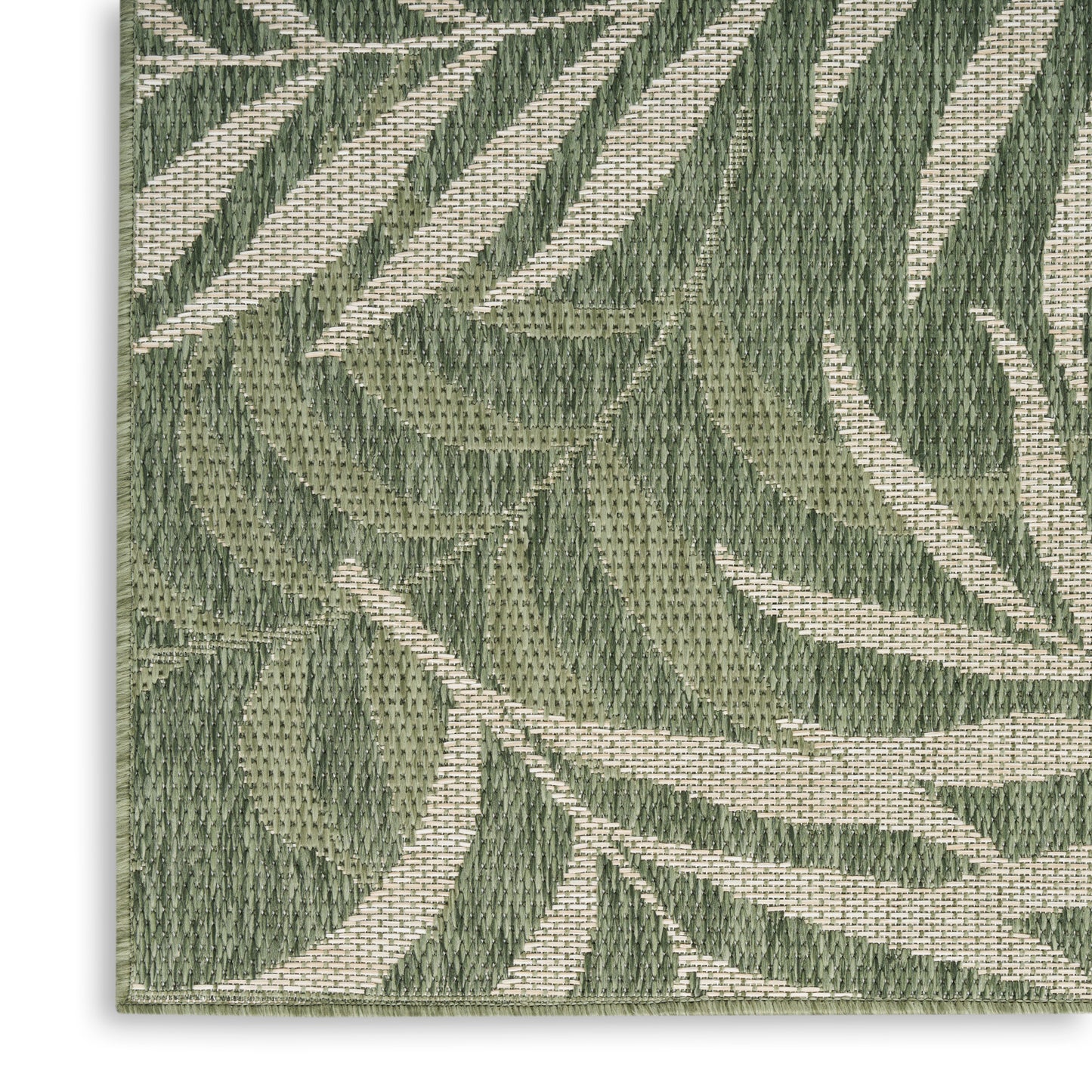 Close-up of olive green botanical leaf pattern on beige woven outdoor rug; tapestry-style texture.