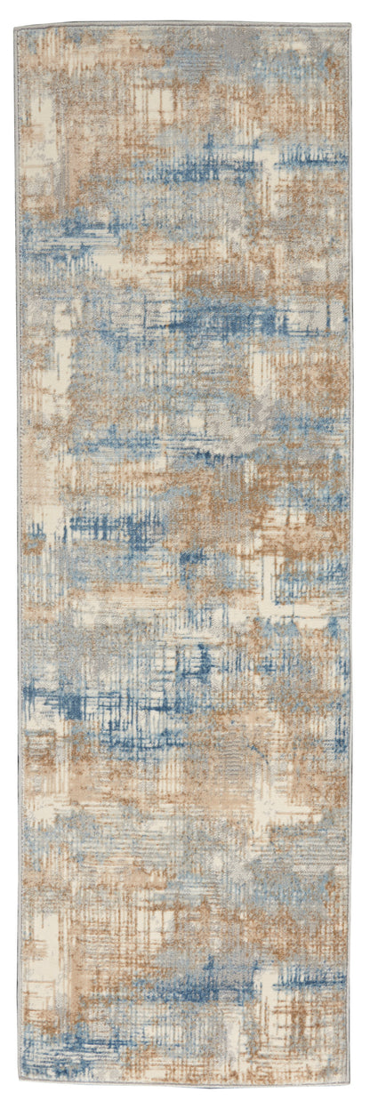 Abstract pattern rug in beige, tan and blue with a soft pile and muted tones.