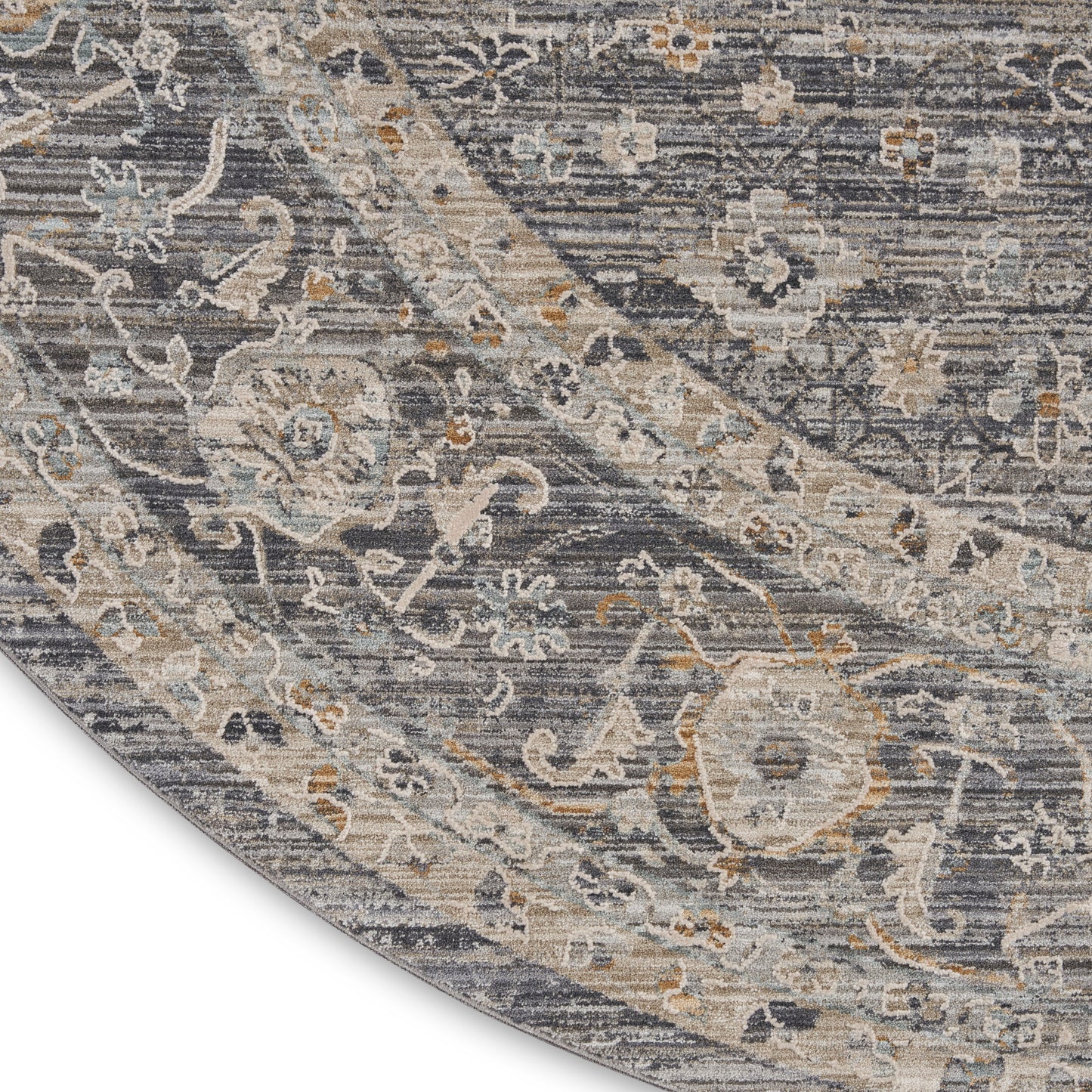Antique blue-gray oriental rug with cream, beige, and pale gold floral Paisley pattern; curved corner.