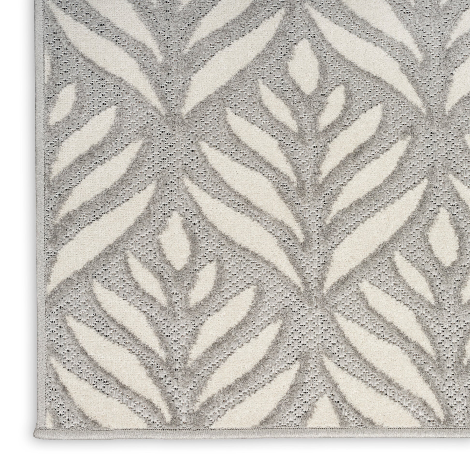 Gray and ivory botanical rug with a textured loop-pile and large leaf pattern; rectangular, modern home decor.