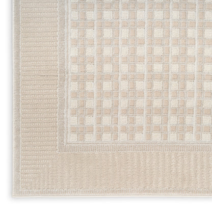 Beige and cream flatwoven rug with a tiled grid pattern and ribbed border.