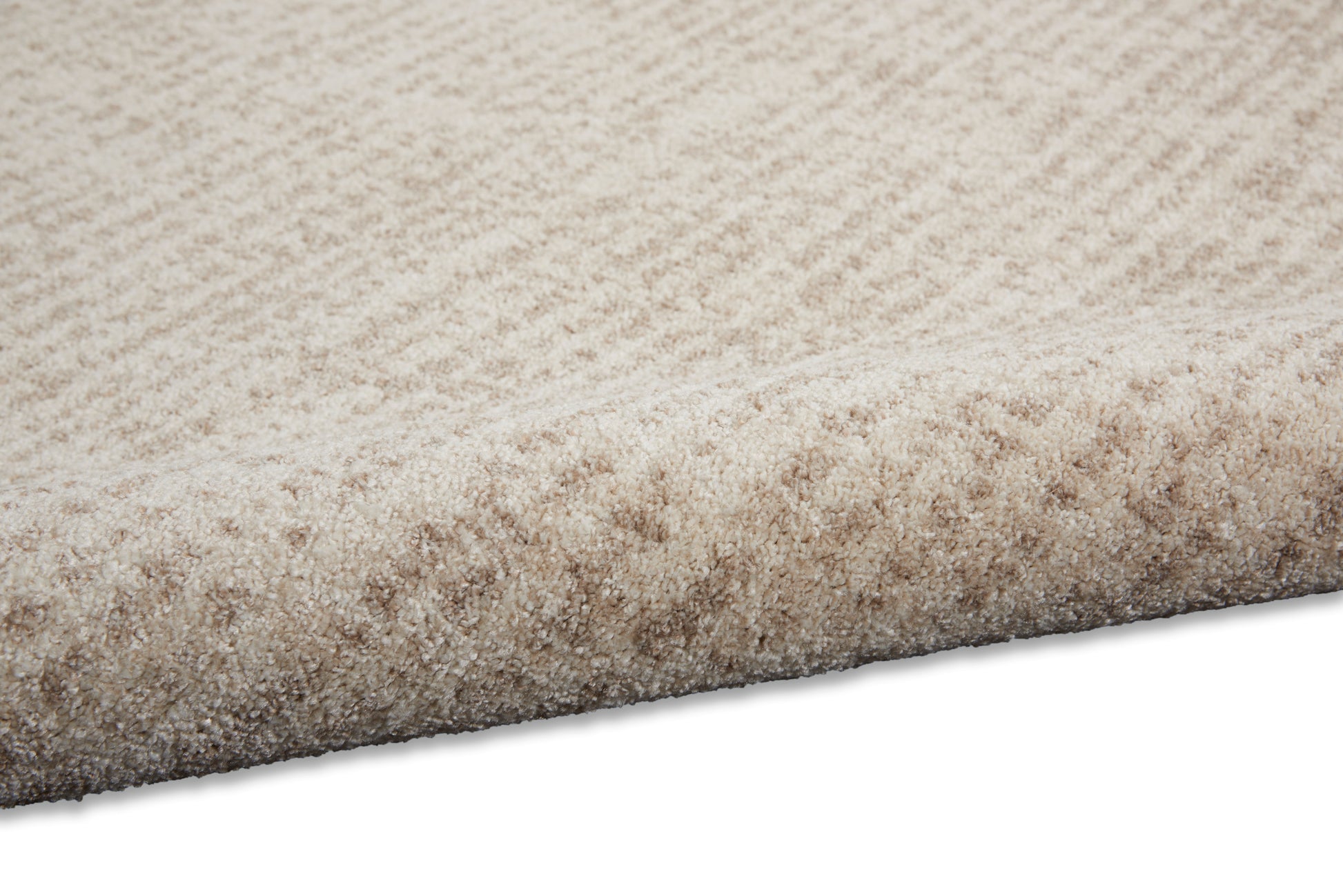 Beige rectangular shag rug with dense, plush high-pile texture for cozy living room decor.