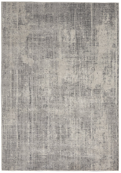 Gray distressed area rug with abstract pattern and subtle linear texture.