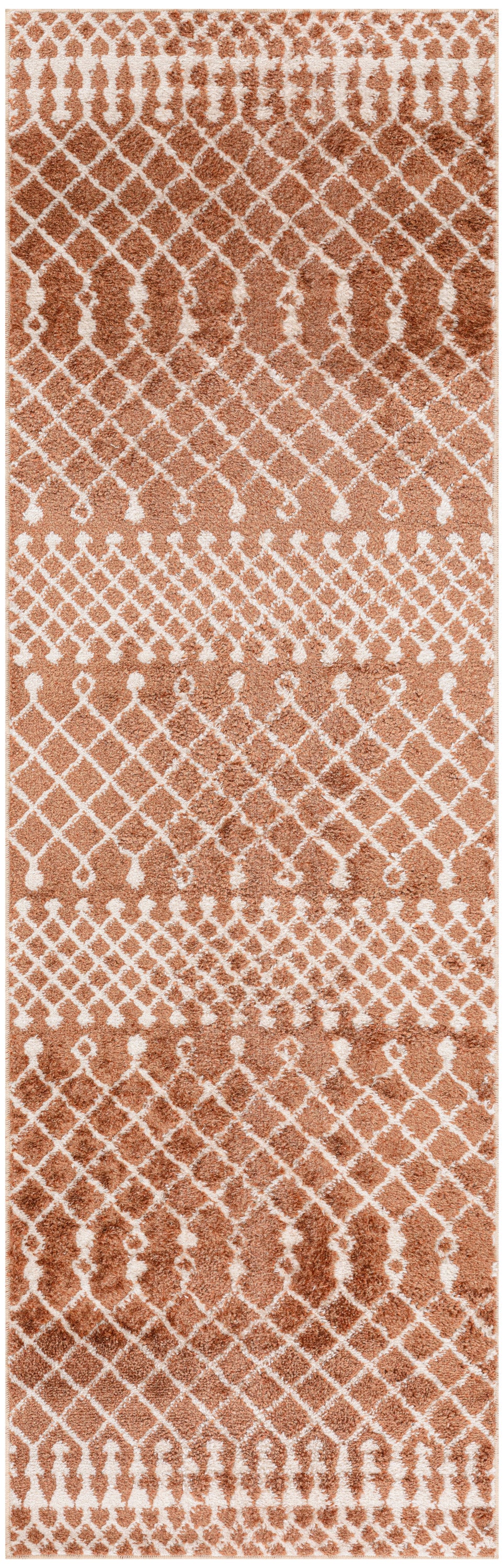 Rectangular copper-brown rug with white lattice and teardrop motifs; warm geometric pattern for living rooms.