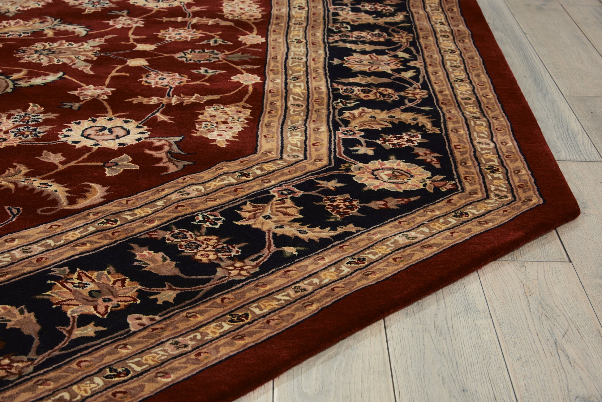 Red oriental rug with navy & gold floral border on light wood floor; octagonal traditional rug with vines & medallion motifs.