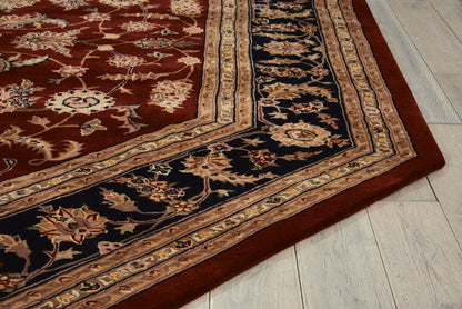 Red oriental rug with navy & gold floral border on light wood floor; octagonal traditional rug with vines & medallion motifs.