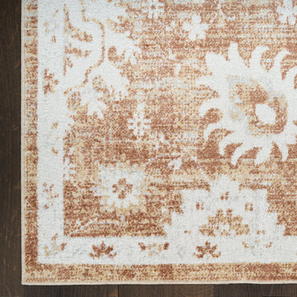 Brown and ivory floral bordered area rug with a distressed pattern; rectangular, rustic style for living room.
