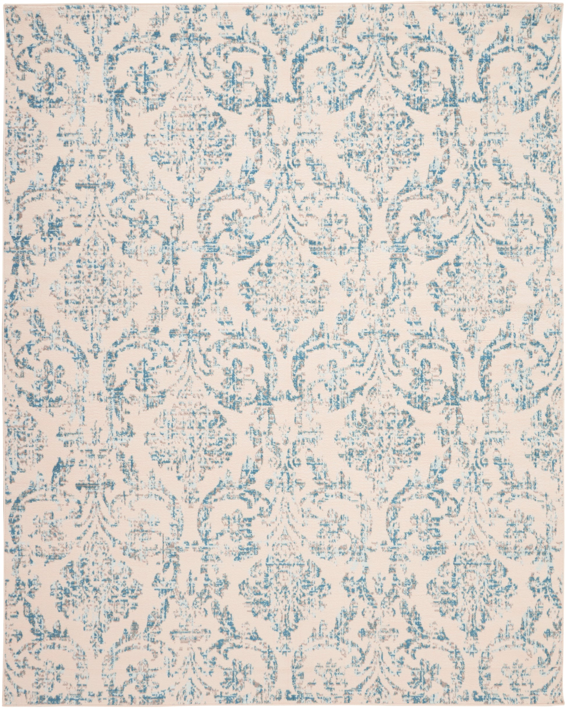 Light beige rug with blue damask floral pattern and scrolling medallions; elegant vintage-style decor.