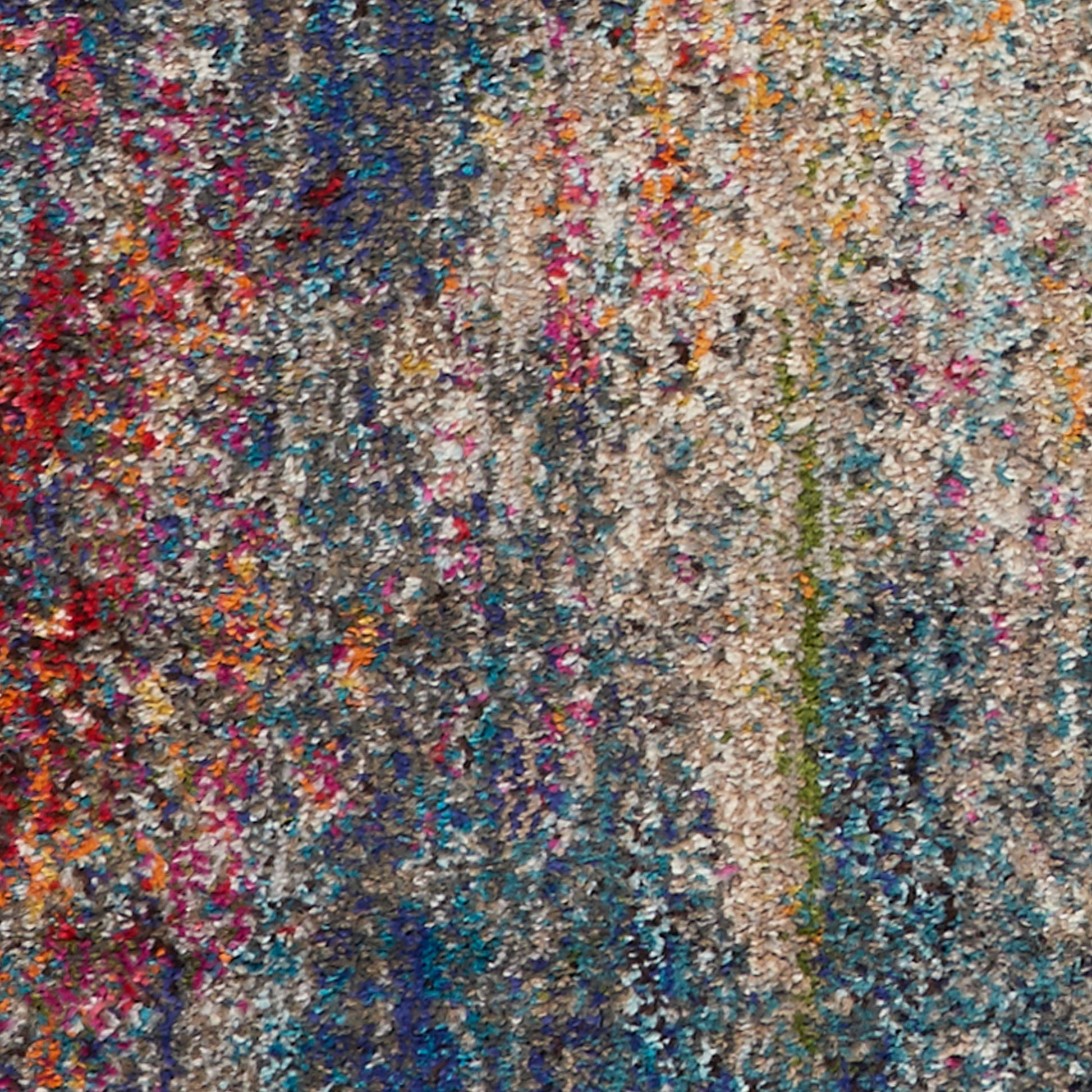 Dense multicolor shag rug with chunky looped fibers in blues, pinks, oranges and beige.
