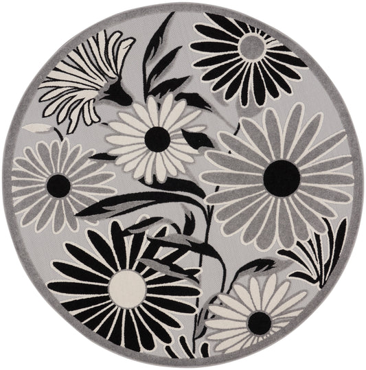 Round gray rug with black and white daisy floral pattern; contemporary circular area rug.