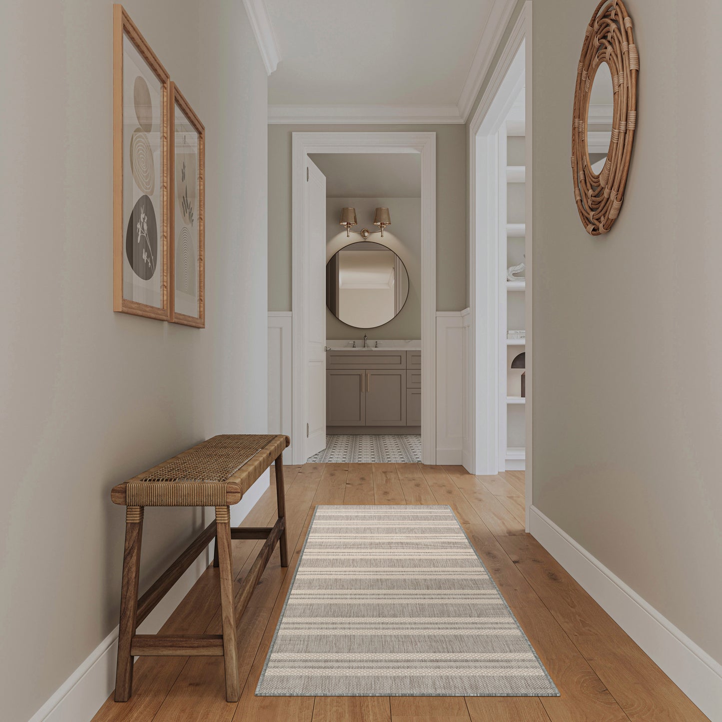 Neutral hallway with wooden bench, striped rug, round wicker mirror; opens to bathroom with round mirror above vanity.