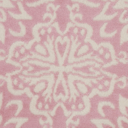 Soft pink fabric with white ornate damask pattern and symmetrical floral motifs.