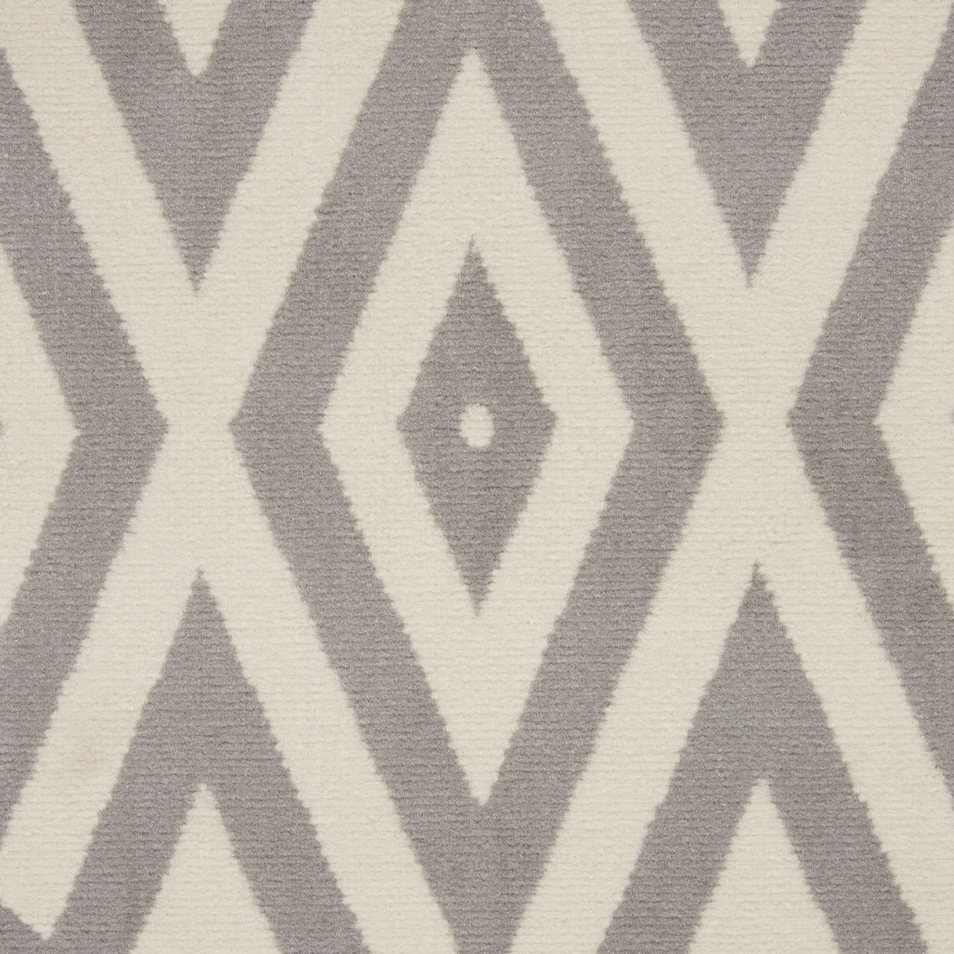 Grey and cream diamond chevron rug with a textured woven surface and repeating geometric pattern.
