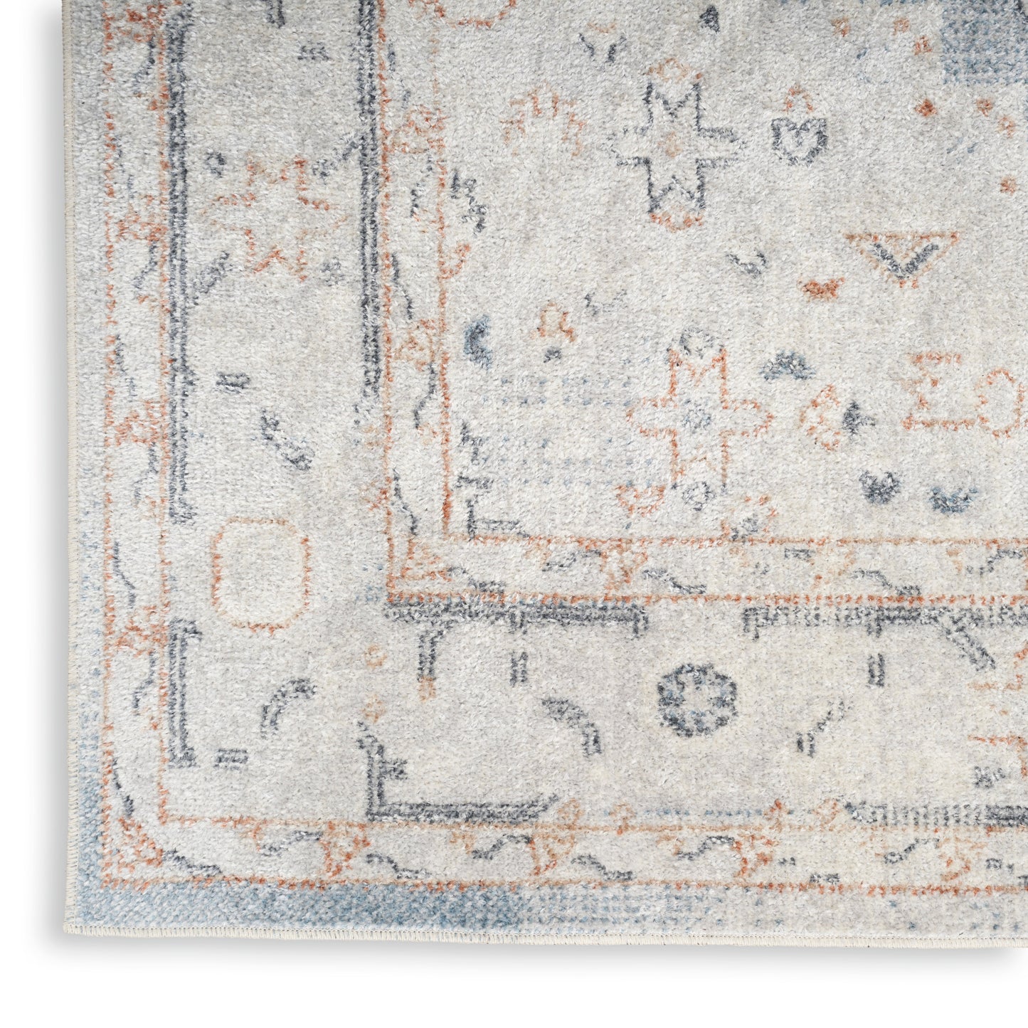 Distressed light blue-gray rug with orange border and subtle oriental motifs, fringe edge