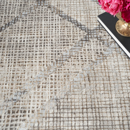 Beige patterned area rug with brown and gray grid design; pink peony bouquet in brass vase on a black notebook in corner.
