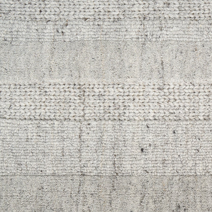 Light gray woven rug with horizontal striped bands and chunky knit texture.