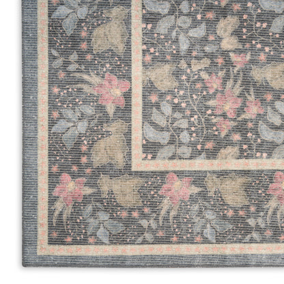 Rectangular floral rug with blue-gray background, pink flowers, beige border and inner trim; woven texture.