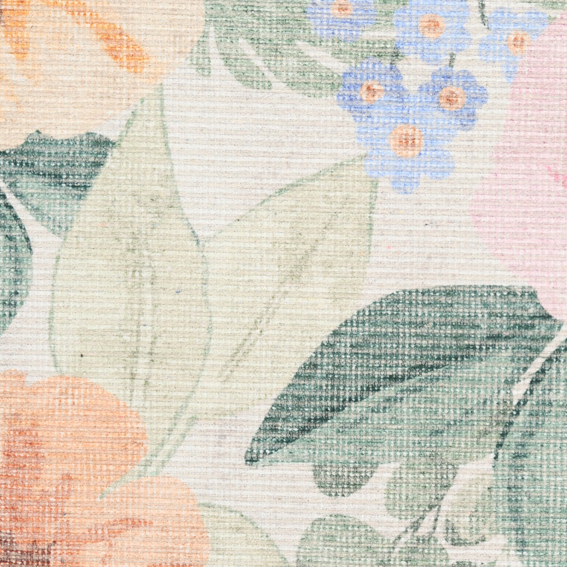 Pastel floral woven rug with peach blossoms, green leaves & small blue flowers.