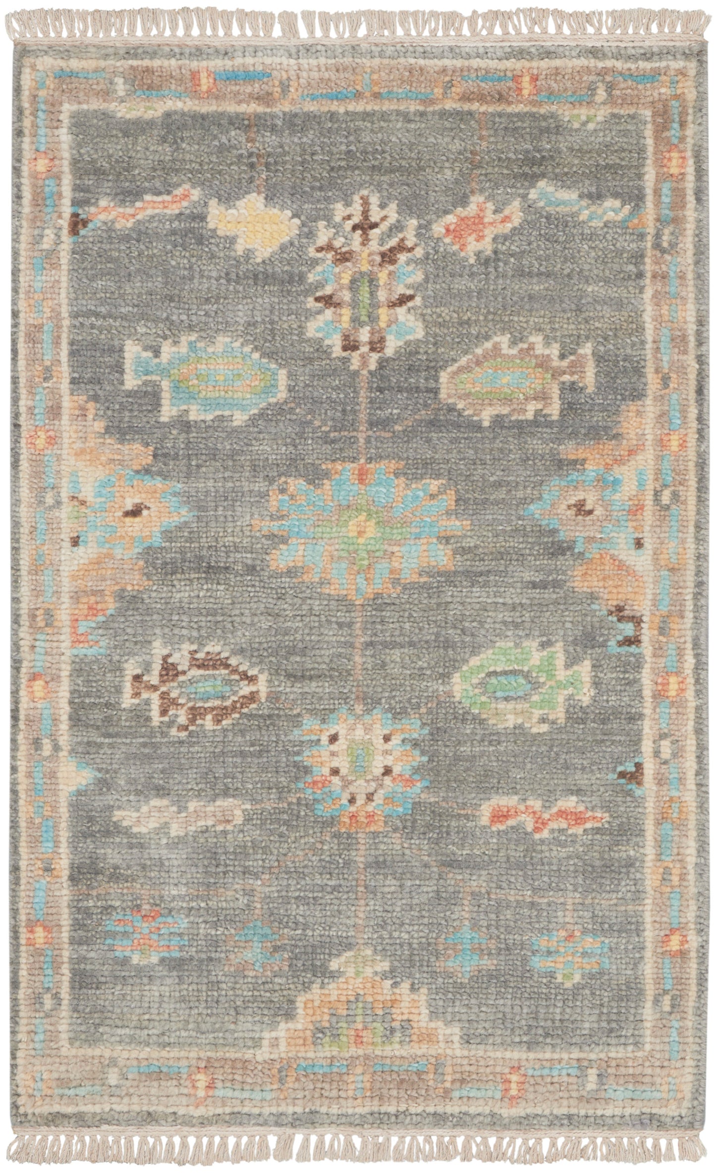 Grey textured rug with pastel floral medallions, light blue and peach border, beige trim, fringed ends.
