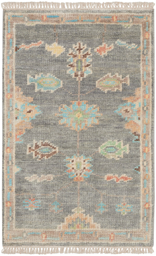 Grey textured rug with pastel floral medallions, light blue and peach border, beige trim, fringed ends.