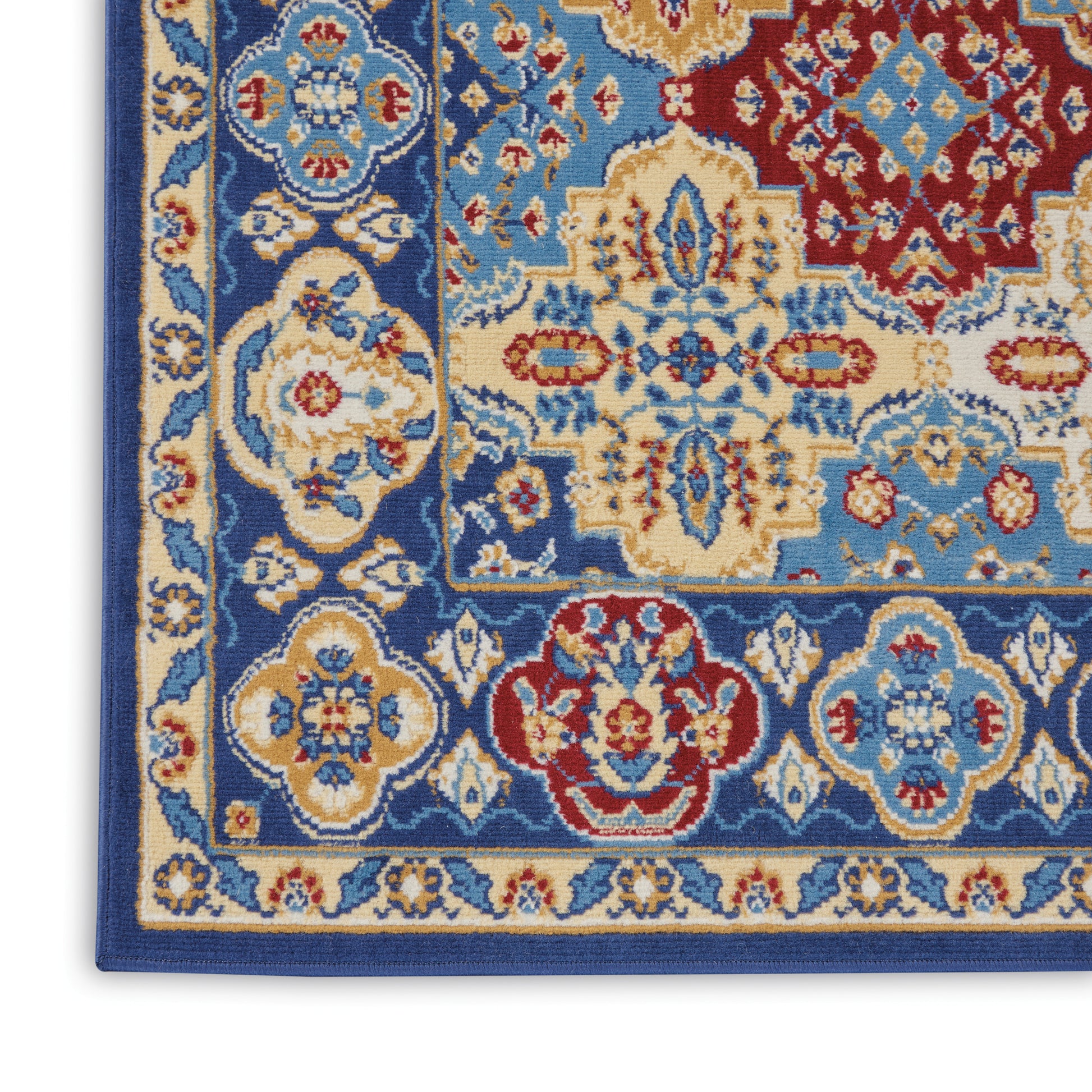 Woven wool rug close-up in blue, ivory, and red with ornate floral medallions and layered borders.