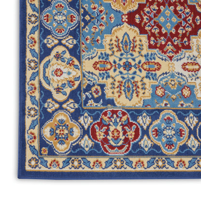 Woven wool rug close-up in blue, ivory, and red with ornate floral medallions and layered borders.