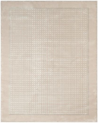 Beige rectangular woven rug with a subtle square-dot pattern and double border; neutral, cozy, versatile decor piece.