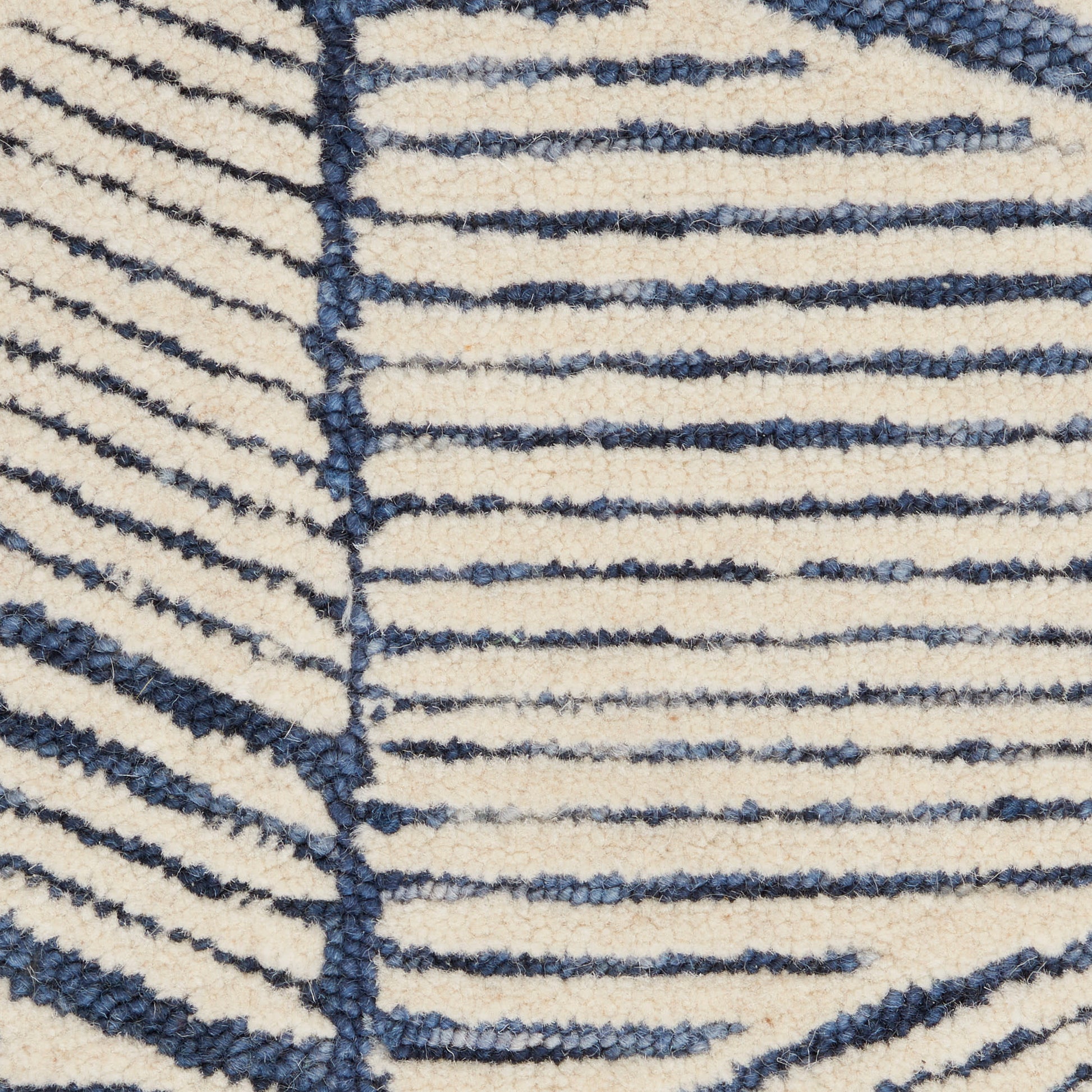 Cream shag rug with navy blue linear stripes forming a bold geometric pattern.