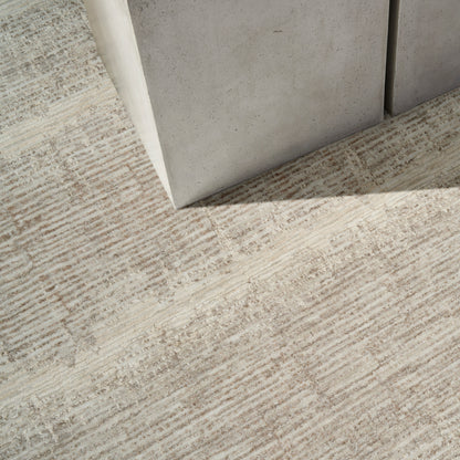 Light gray and beige textured rug in industrial-modern decor.