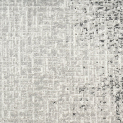 Light gray woven textile close-up with a subtle grid pattern and darker speckled edge on the right.