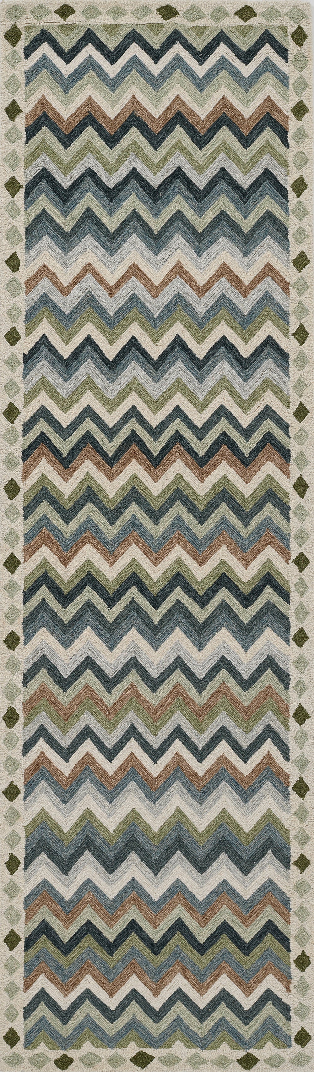 Woven textile runner with multicolor chevron zigzags in blues, teals, browns and creams; bordered edges.