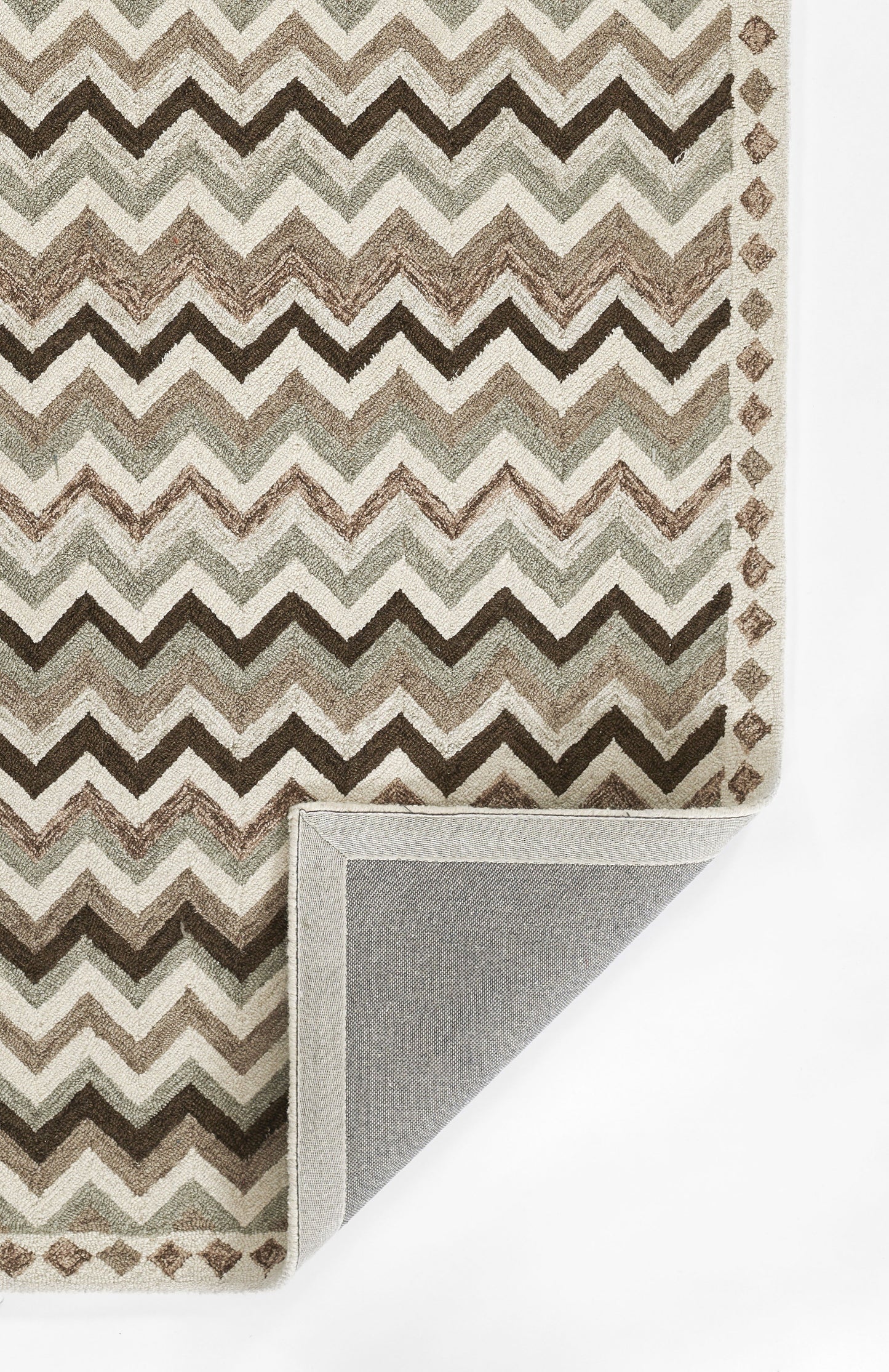 Chevron rug in browns, beiges & ivory with diamond border; corner folded to reveal gray backing.