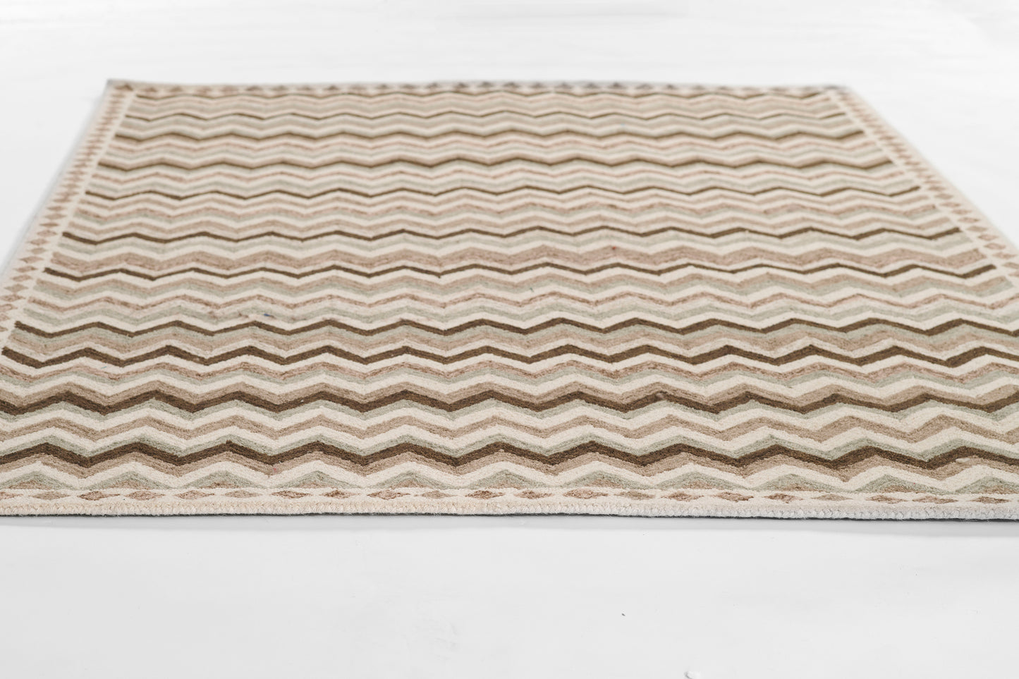 Beige chevron-patterned rug with cream and brown zigzag stripes, rectangular.