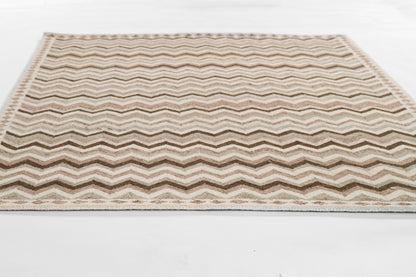 Beige chevron-patterned rug with cream and brown zigzag stripes, rectangular.