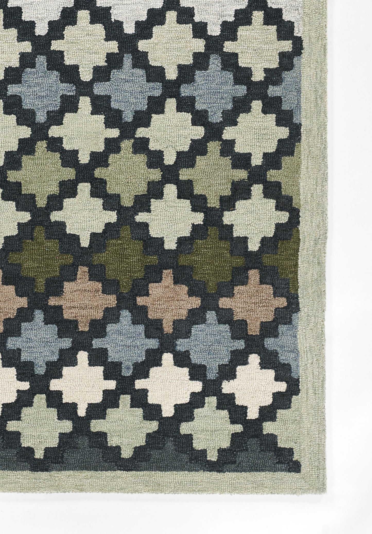 Woven area rug with a repeating diamond trellis pattern in cream, navy, blue-gray, greens and browns; pale sage border.