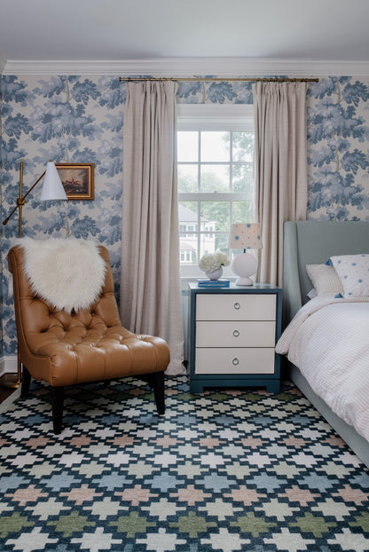 Blue Diamond Trellis 2' x 3' rug on the floor in a cozy bedroom with blue accents.