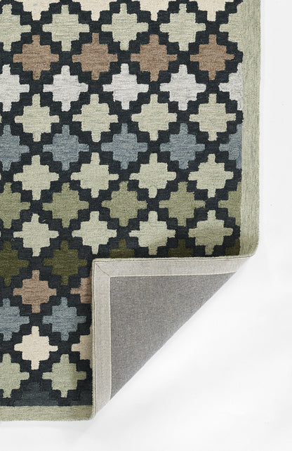 Geometric rug with a diamond trellis pattern in navy, cream, tan, gray and olive; folded corner reveals gray backing.
