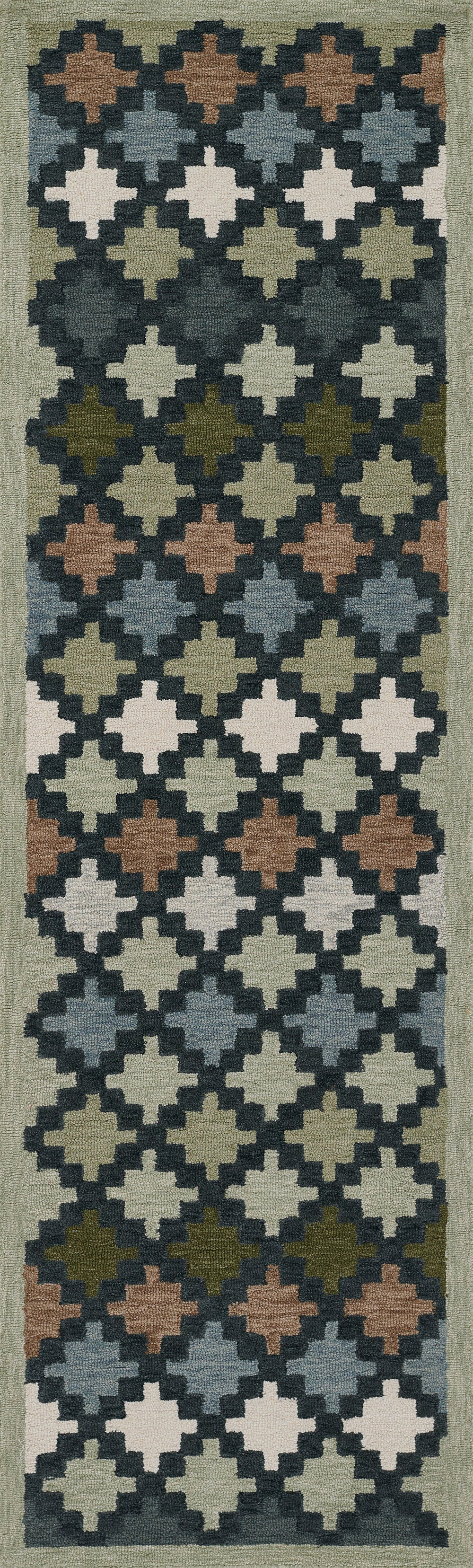Long narrow runner rug with repeating quatrefoil blocks in blues, creams, olive, tan, and brown on a dark background.