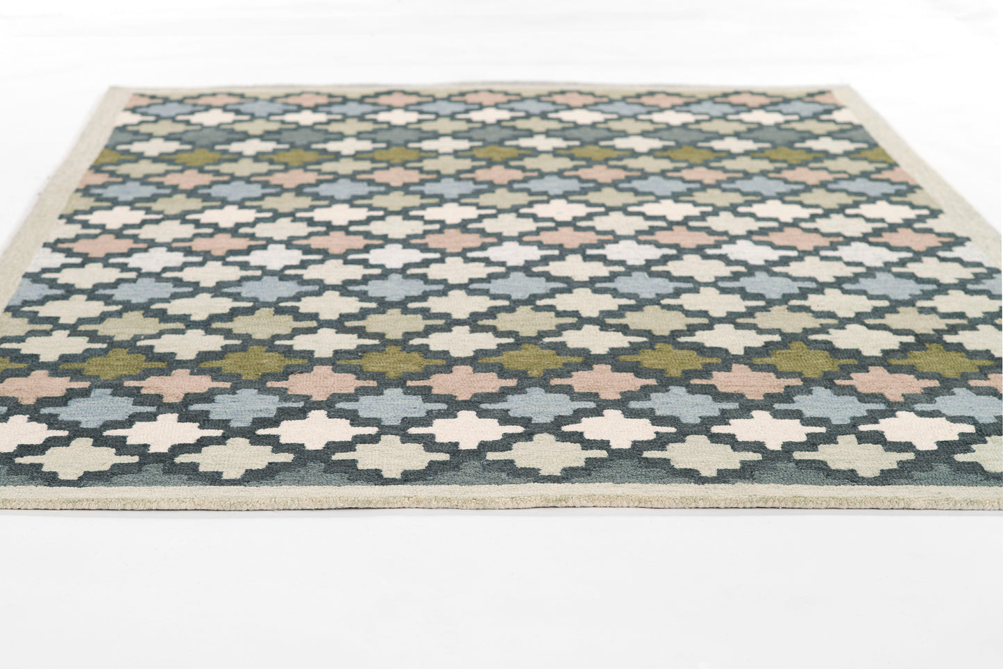 Rectangular blue-and-cream flatweave rug with diamond trellis pattern, pink/olive accents, beige border.