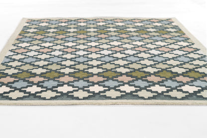 Rectangular blue-and-cream flatweave rug with diamond trellis pattern, pink/olive accents, beige border.
