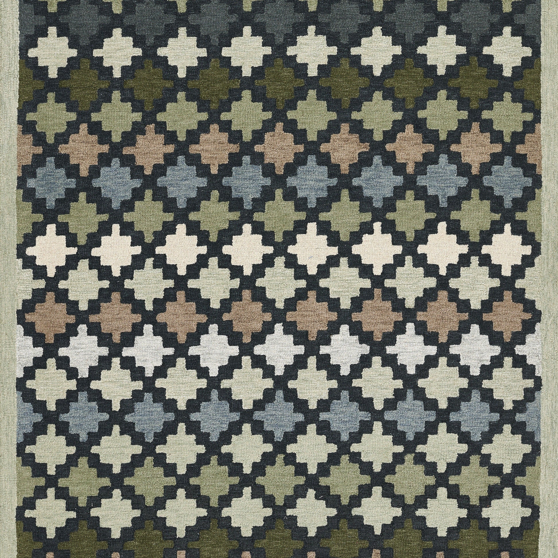 Woven rug with a diamond lattice of cross-like quatrefoil motifs in a gradient of blues, greens, browns and creams.