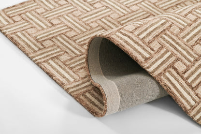 Beige-tan geometric woven rug with a lattice pattern; rolled corner showing the soft gray underside.