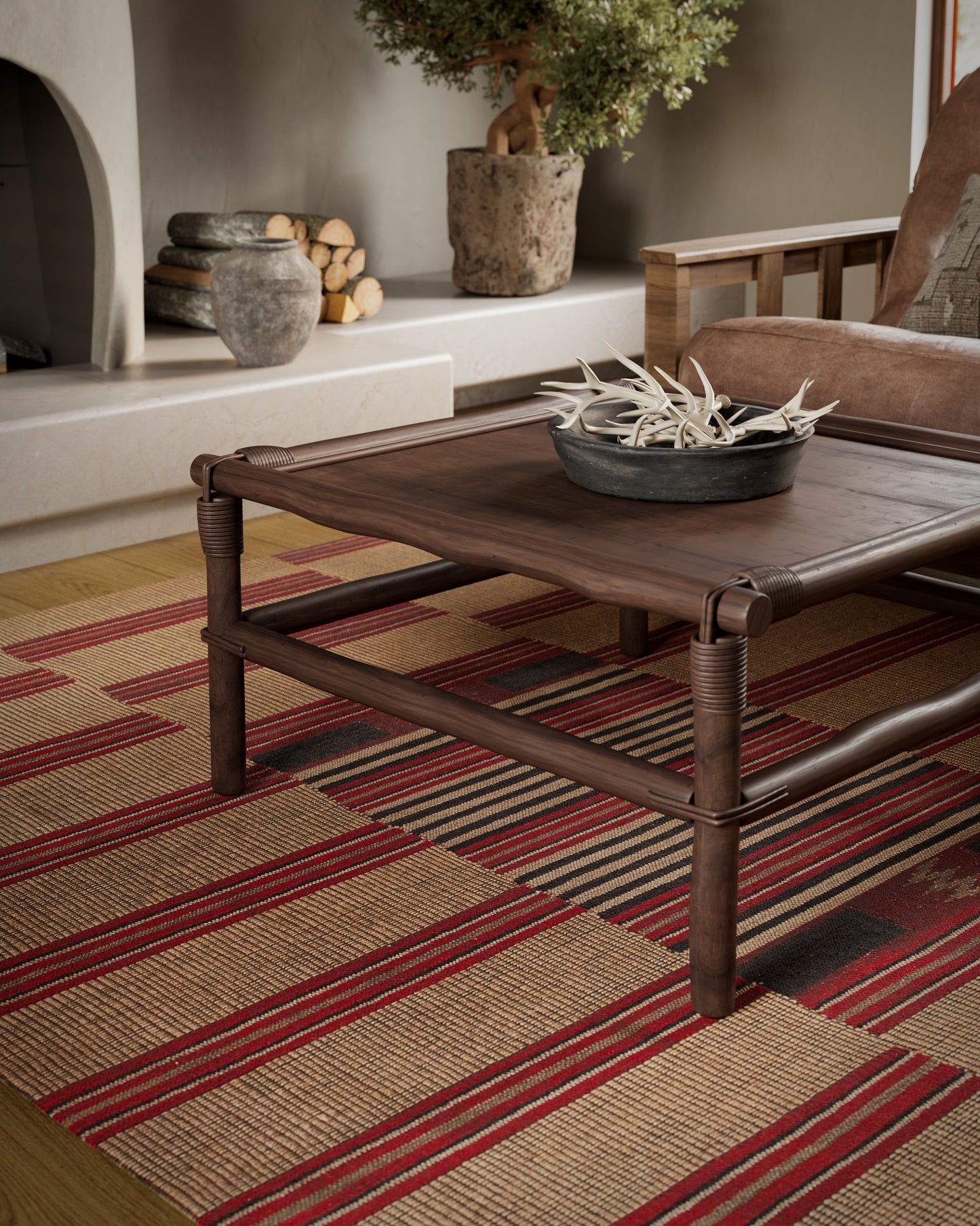 Dark brown wood coffee table with woven rattan frame on a red-tan striped rug in a rustic living room.