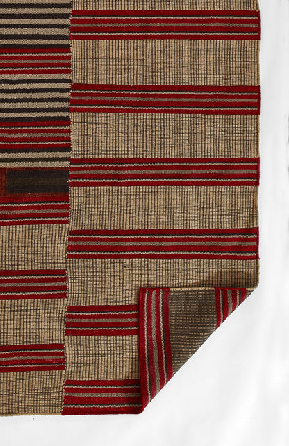 Woven rug with red and beige horizontal stripes; textured fibers and folded corner.