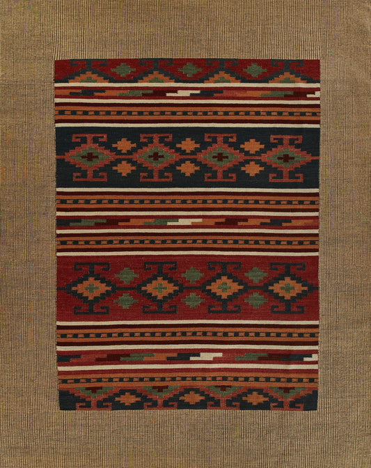 Rectangular kilim rug with geometric patterns in red, navy, green and ivory; flat-weave tribal floor decor.