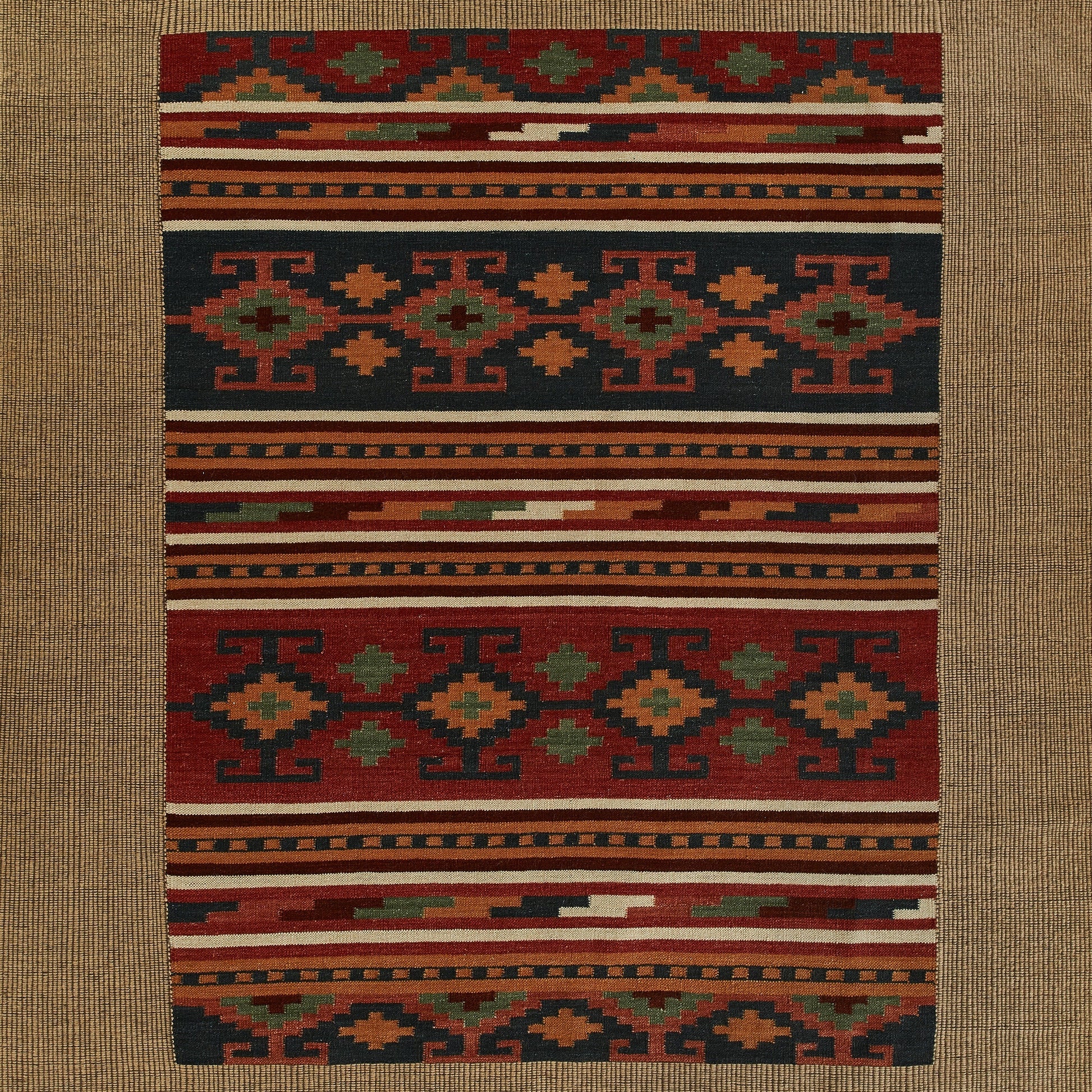 Rectangular kilim-style flat-weave runner rug with geometric tribal motifs in red, navy, orange, cream & green.