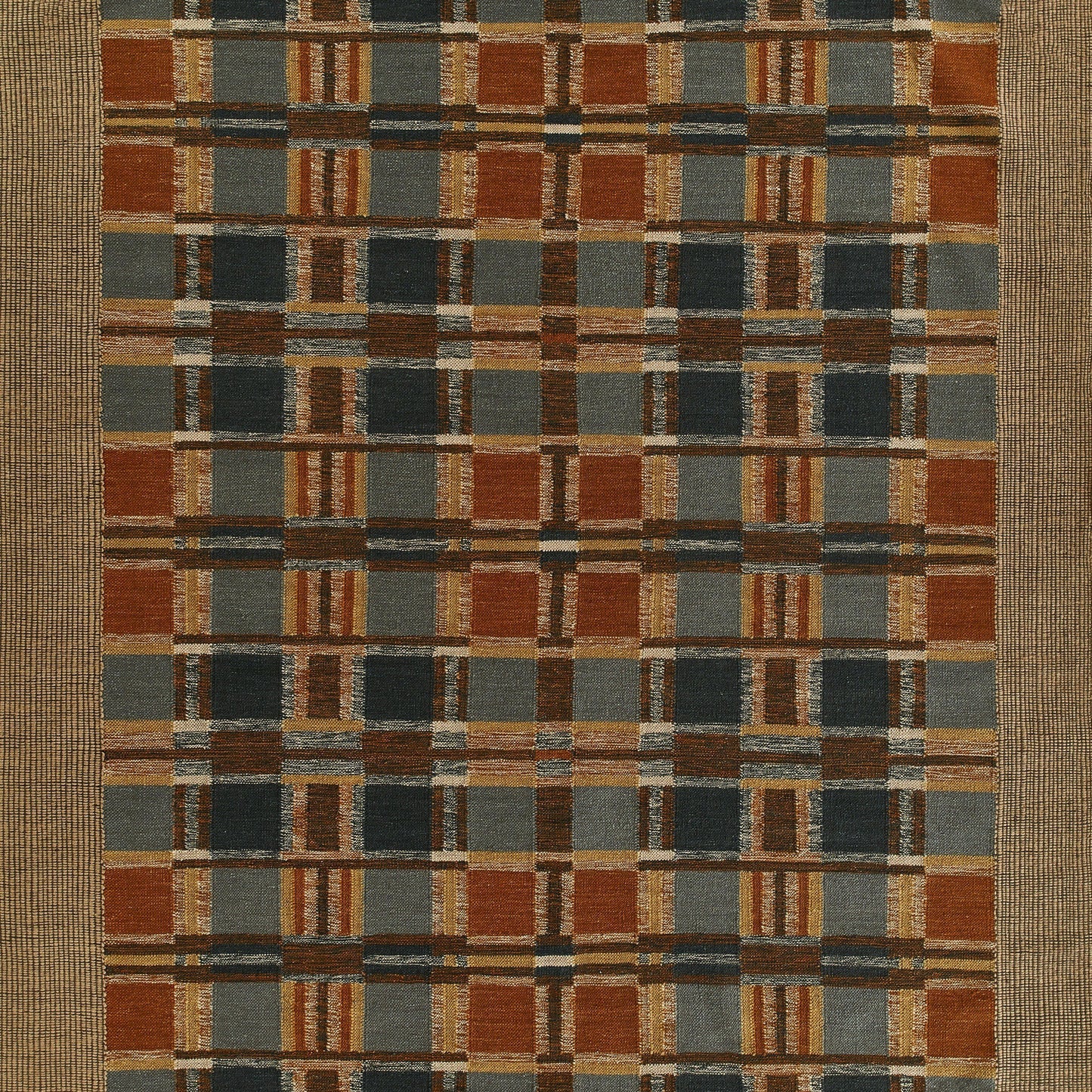 Rectangular woven rug with a rust-orange, slate blue, gray and tan plaid pattern, bordered by a natural beige frame.